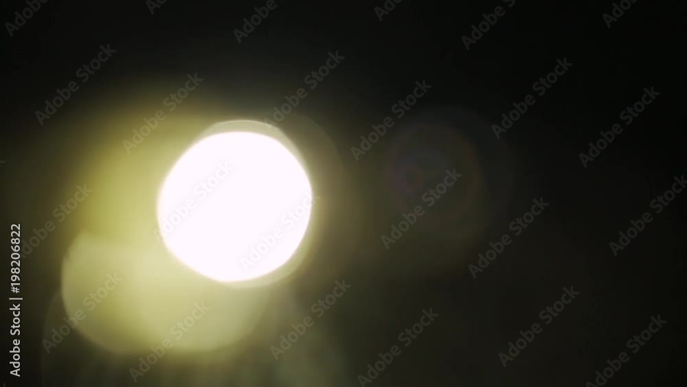 Rotating warm light in the dark. Creative motion transition, lens flare, light leaks, overlays. Rotating warm light in the dark. Creative motion transition, lens flare, light leaks, overlays.