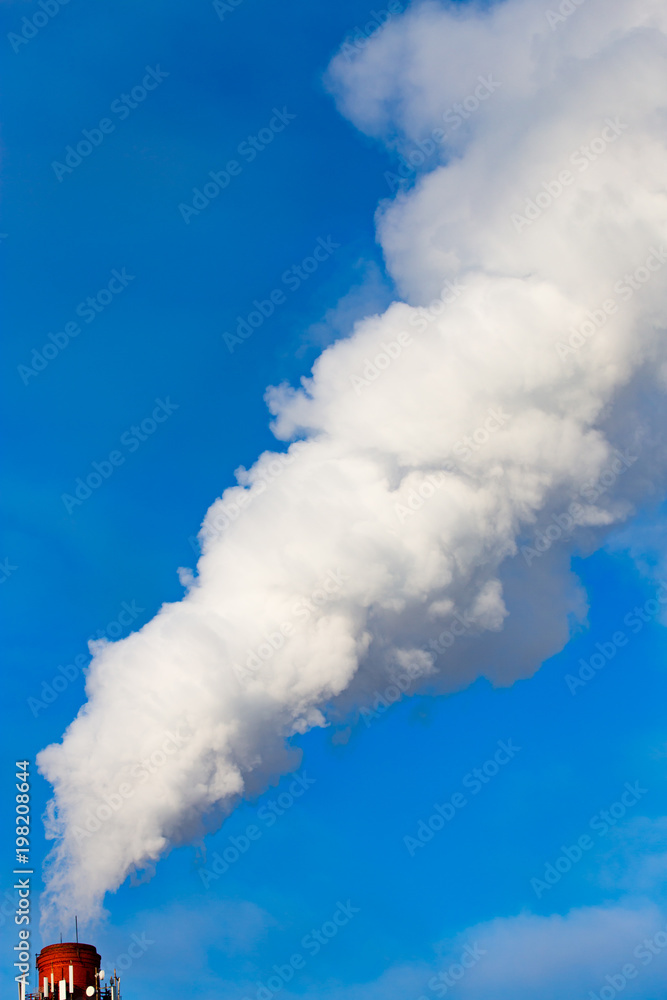 smoke from a pipe in the factory against a blue sky smoke from a pipe in the factory against a blue sky