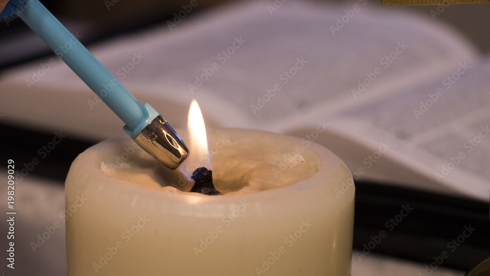 Naklejka premium light of Christ (the lighter lights candles by Bible)