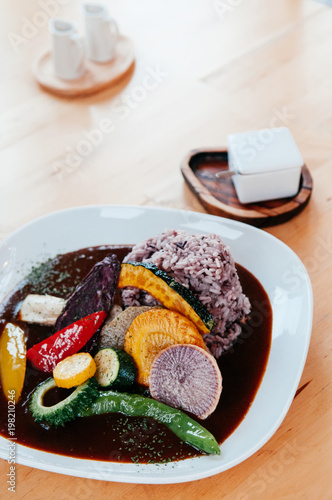 Beautiful Japanese curry with grill vegetables with brawn rice on white plate