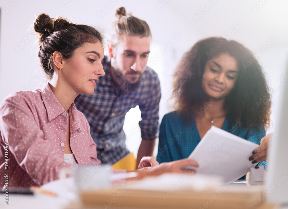 Multiracial group of students working on a common project