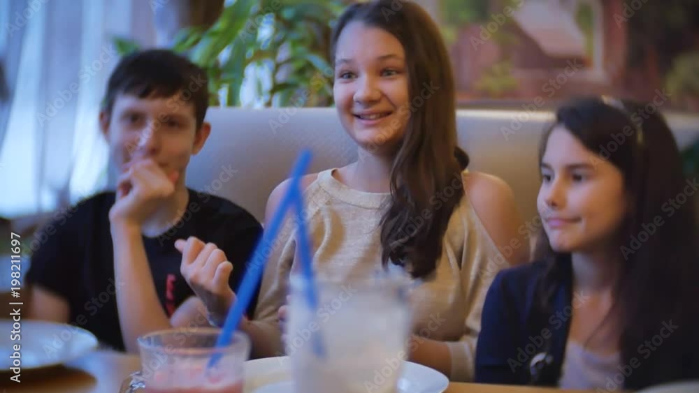 group of children in a cafe drink milkshake. teenagers boy kids children in cafes slow motion video indoors indoors fun joy communication group of children in a cafe drink milkshake. teenagers boy kids children in cafes slow motion video indoors indoors fun joy communication