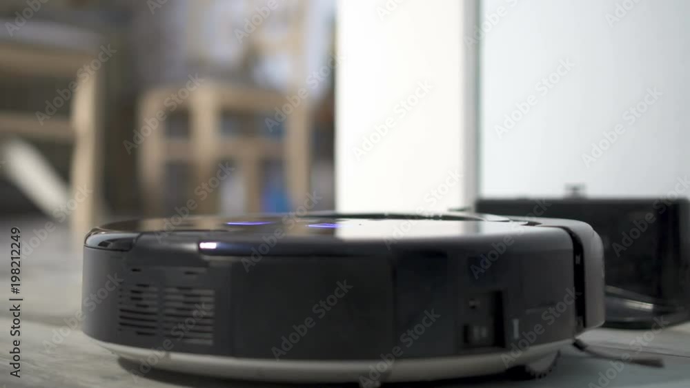 Automatic Vacuum Cleaning Robot coming to dock station for Self-Charging. In slow motion Automatic Vacuum Cleaning Robot coming to dock station for Self-Charging. In slow motion