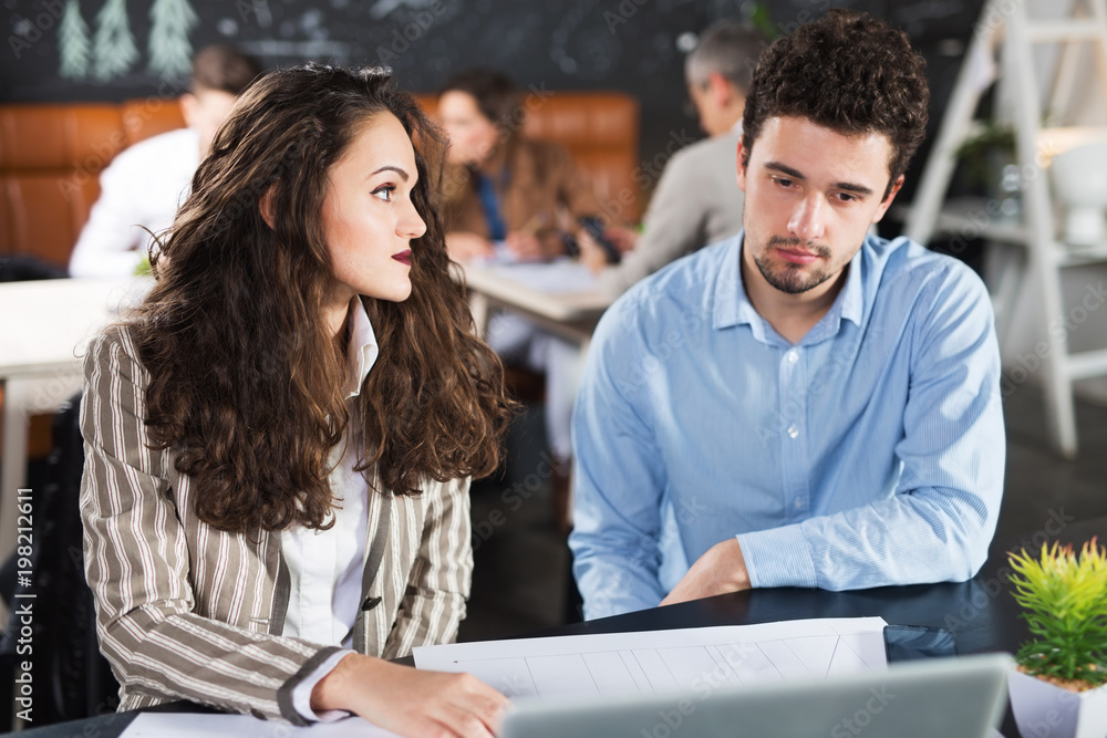 Young colleagues working together in a cafe Young colleagues working together in a cafe