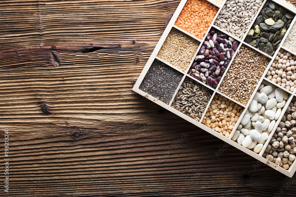 Healthy food and diet theme. Lentils, peas, beans, protein food in bowls, on a wooden table. Healthy food and diet theme. Lentils, peas, beans, protein food in bowls, on a wooden table.