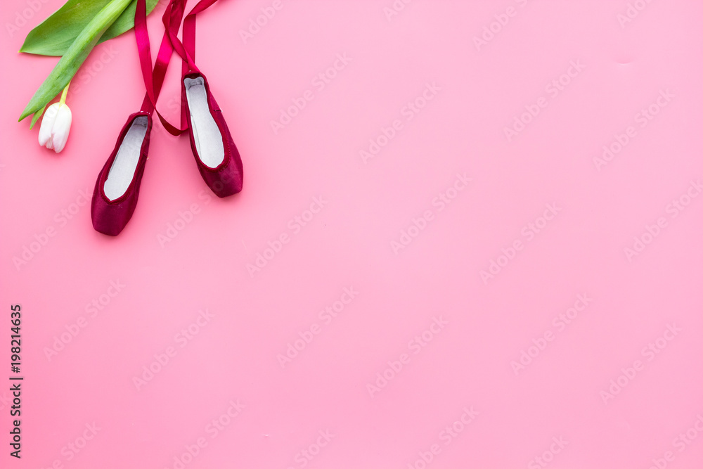 Professional dance shoes. Ballet concept. Pointes on pink background top view copy space Professional dance shoes. Ballet concept. Pointes on pink background top view copy space