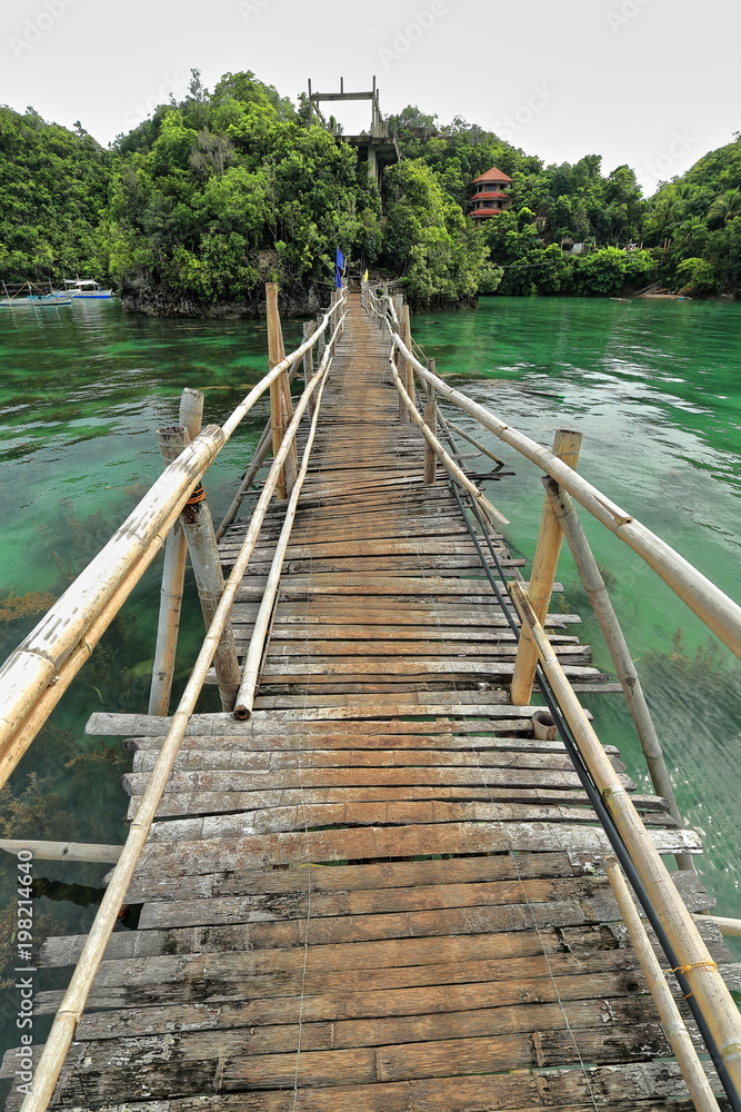Bamboo and wooden planks footbridge with flags-Tinagong Dagat island. Sipalay-Philippines. 0363