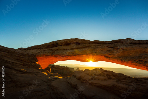Beautiful Canyonlands view  from Mesa Arch  under warm surise light  on a clear autumn day