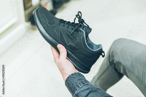 man seek new sneakers in store. shopping concept. shoes fashion buy shopping