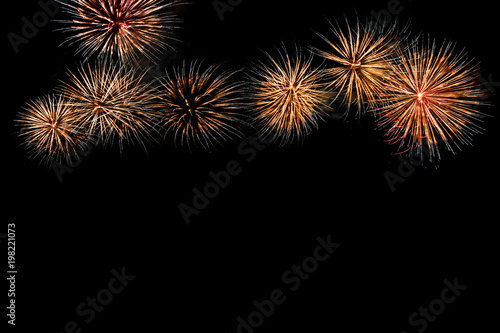 Colored firework background with free space for text. Colorful fireworks at night light up the sky with dazzling display. Use for abstract background.