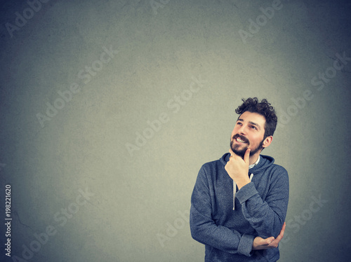 Handsome man thinking looking up