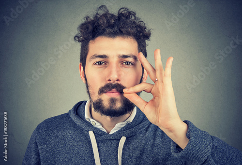 serious man zipping mouth keeping confidential information