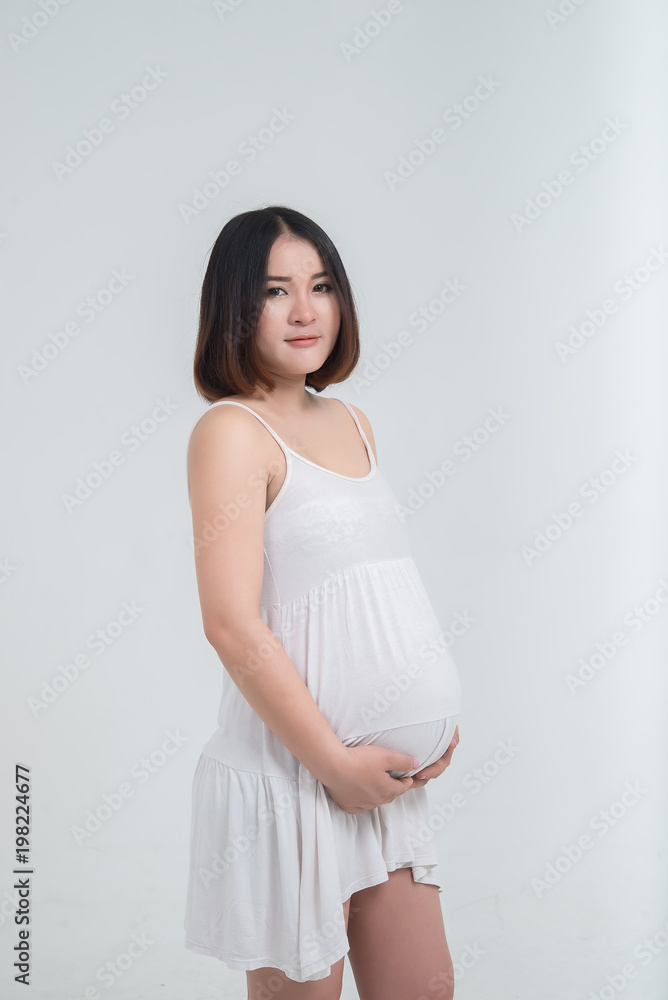 Portrait of asian pregnant woman on white background,thailand people use hand touch belly Portrait of asian pregnant woman on white background,thailand people use hand touch belly