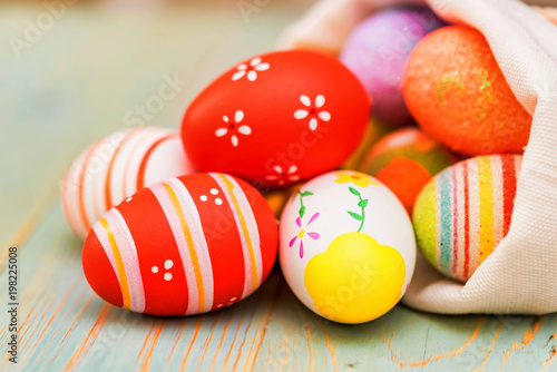 Several colorful Easter eggs in sack close