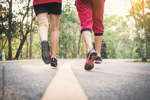 Feet man and woman running on the road for health , color of vintage tone selective and soft focus