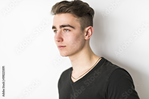portrait of young cute teenager in white wall © Louis-Photo