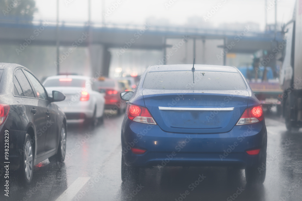 cars in traffic jam on wet road at rainy city evening cars in traffic jam on wet road at rainy city evening