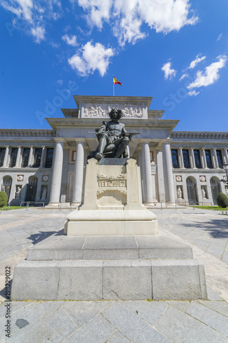 facade of the Prado Museum, walkway with classical sculptures in stone, gallery of ancient art in Spain, Madrid. Sculpture by the painter Velazquez