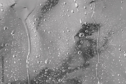 drops of water on a dark surface © taraskobryn