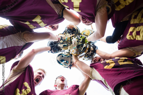 American Football Team players huddle after their victory