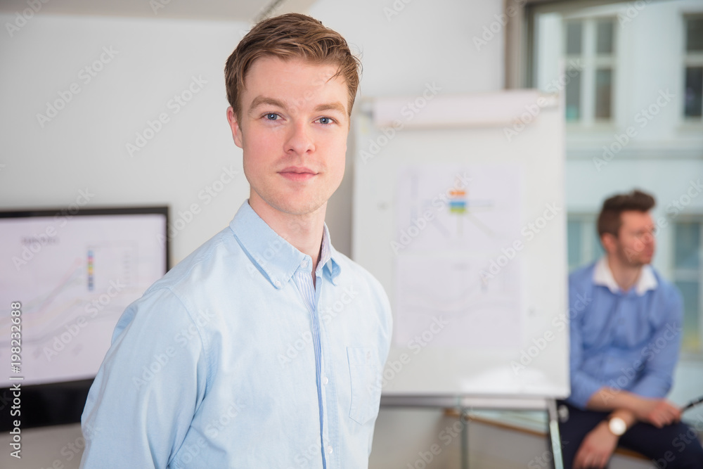 Confident Male Professional Standing In Office