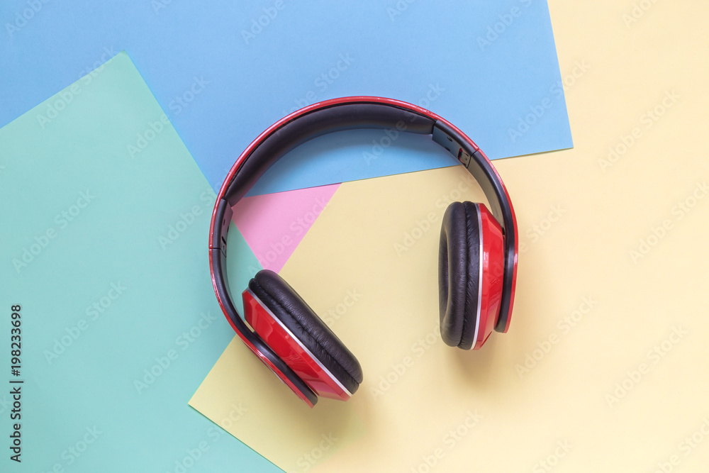 Close up of read headphones on multicolored background. Music minimal concept Close up of read headphones on multicolored background. Music minimal concept