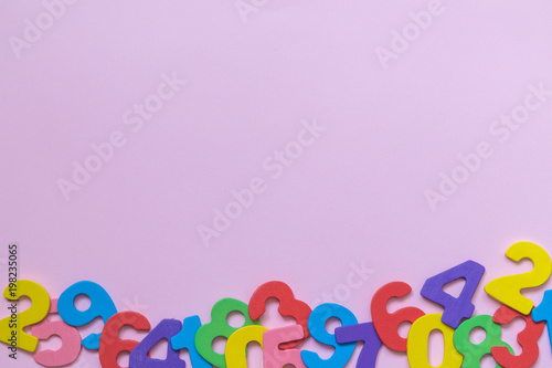 Multicolored numbers on pink background minimalistic concept.