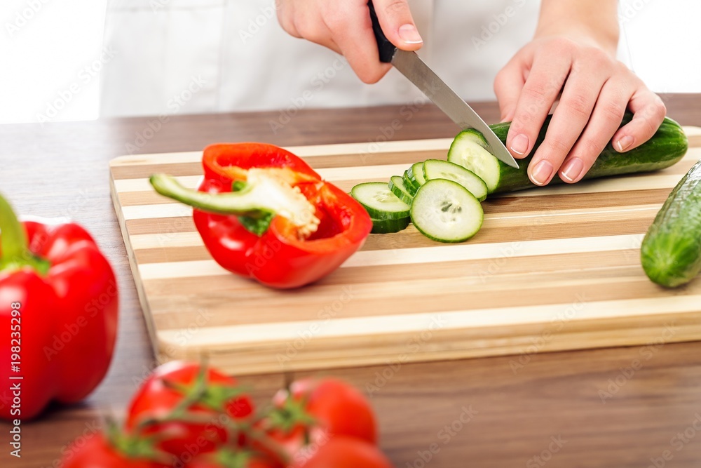 Chef woman cutting cucumber Chef woman cutting cucumber