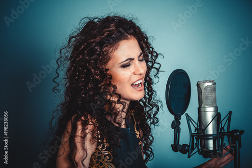 Singer. Woman lady girl singing with microphone singing photo