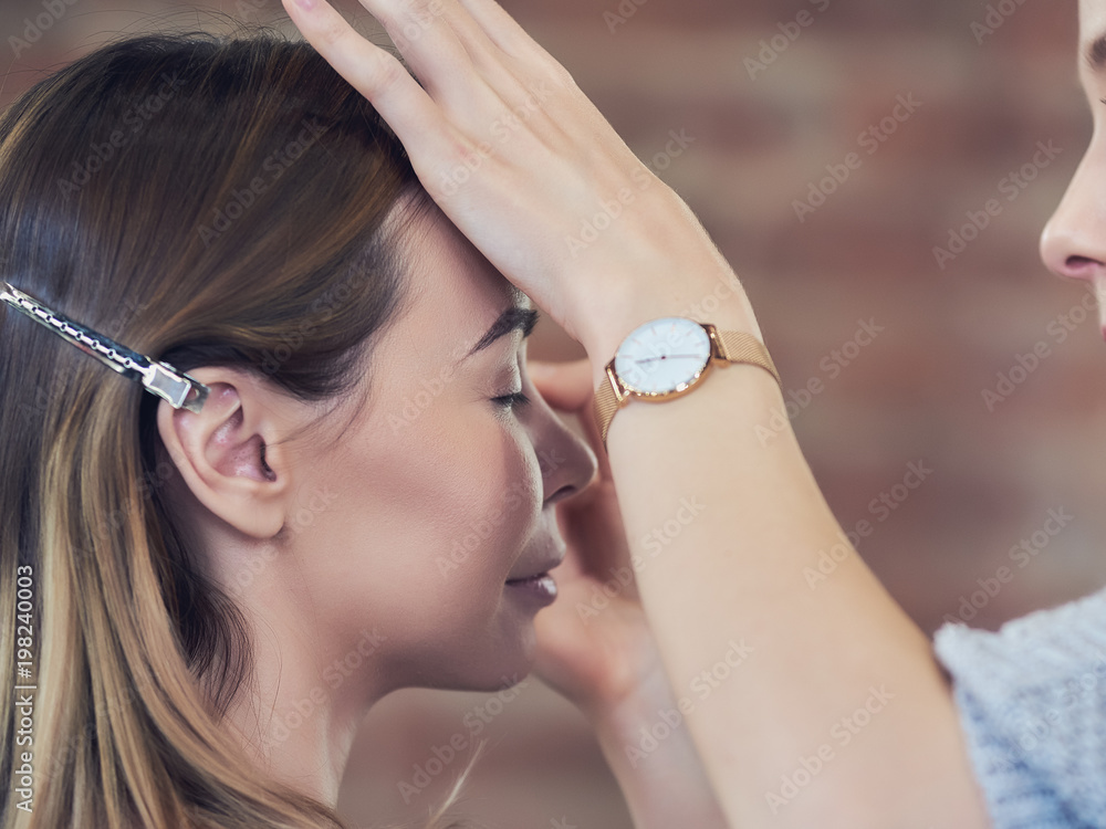 Fototapeta premium Young beautiful europen woman is getting eyebrow service at the beauty shop.