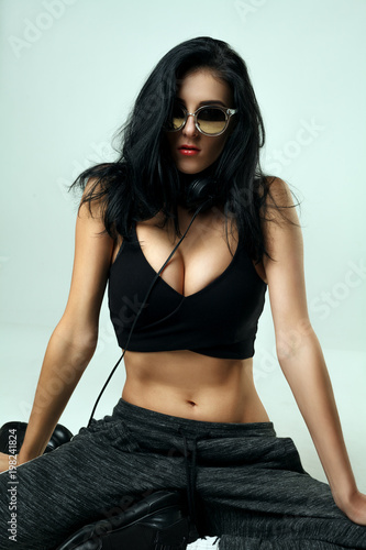 dark hair sporty fitness model in sunglasses looking confident 