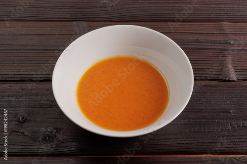 Pumpkin soup with tomatoes on a table