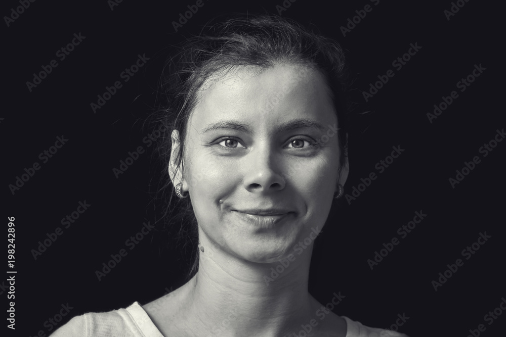 Black and white portrait of young woman on black background. Natural human face with realistic emotion. Portrait girl in retro style. Black and white portrait of young woman on black background. Natural human face with realistic emotion. Portrait girl in retro style.