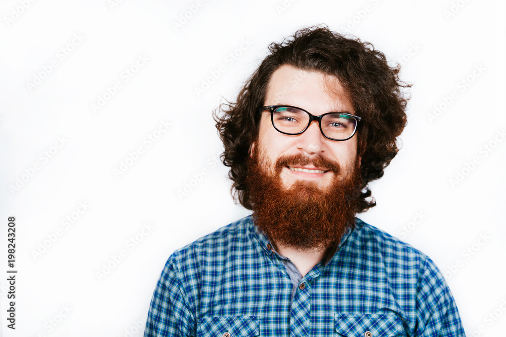 Smiling Bearded man in shirt and eyeglasses looking confident at camera on white background. Portrait of handsome positive young bearded man looking at camera. Smiling Bearded man in shirt and eyeglasses looking confident at camera on white background. Portrait of handsome positive young bearded man looking at camera.