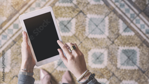 Stand up woman holding tablet photo