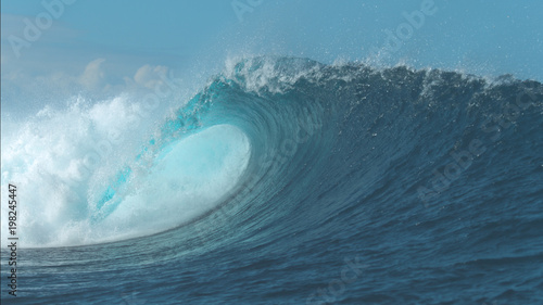 CLOSE UP: Powerful Cloudbreak wave violently swirls in awesome sunny weather.