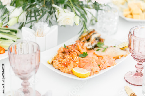 Fish platter. Plate with seafood on the table, snacks at the banquet, wedding banquet, table setting, dinner food, gala dinner.
