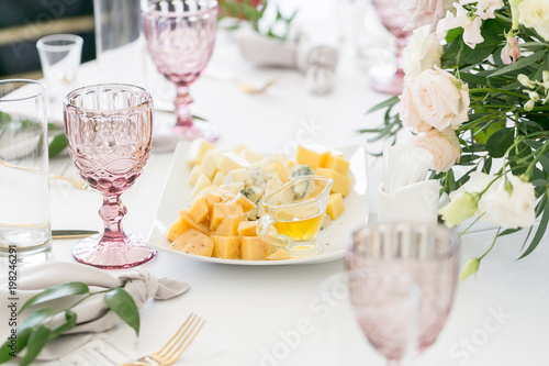 Cheese platter. Plate with food on the table, snacks at the banquet, wedding banquet, table setting, dinner food, gala dinner.
