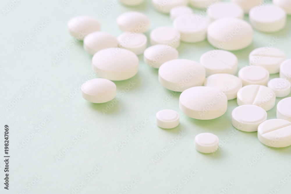 Pharmaceutical medicine pills, tablets and capsules over green Pharmaceutical medicine pills, tablets and capsules over green