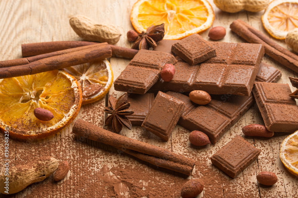 Milk chocolate with nuts and spices. Macro. Milk chocolate with nuts and spices. Macro.