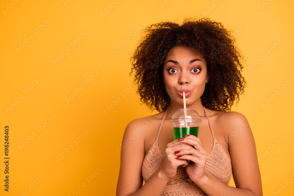 OMG! So delicious! Funny cute attractive careless mixed-race woman is drinking green alcohol cocktail is a plastic cup using a straw, isolated on bright vivid background, copy space OMG! So delicious! Funny cute attractive careless mixed-race woman is drinking green alcohol cocktail is a plastic cup using a straw, isolated on bright vivid background, copy space