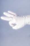 Male hand in latex glove. OK sign. on dark background