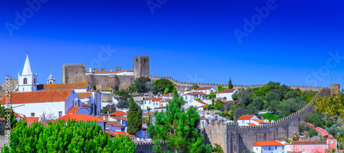 Panoramic view of the beautiful medieval historic center village of Obidos and Castle of Obidos. Wonderful romantic afternoon landscape at sunny weather. District of Leiria  in the centre of Portugal.