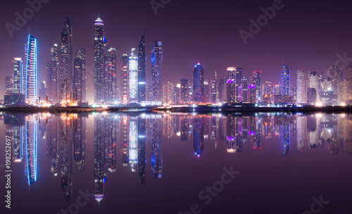 Panoramic view of Dubai Marina skyline with reflection at night  UAE