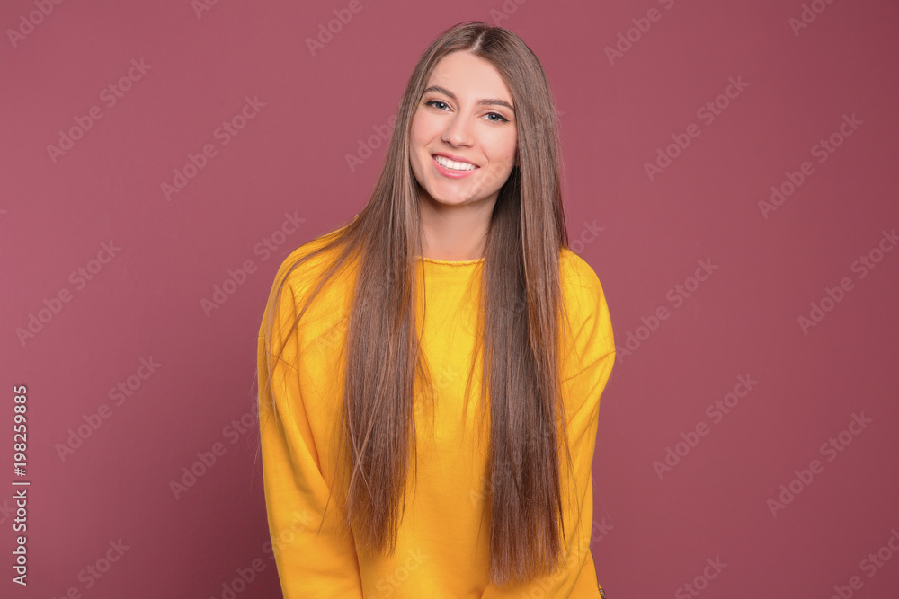 Portrait of young woman with long beautiful hair on color background Portrait of young woman with long beautiful hair on color background