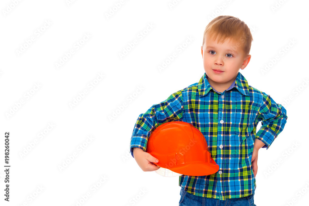 The little boy in the helmet of the builder. The little boy in the helmet of the builder.