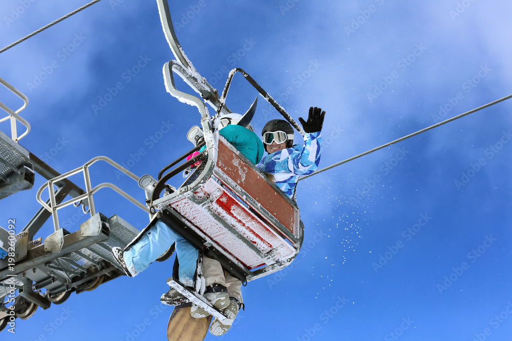 Couple on ski lift at mountain resort. Winter vacation Couple on ski lift at mountain resort. Winter vacation
