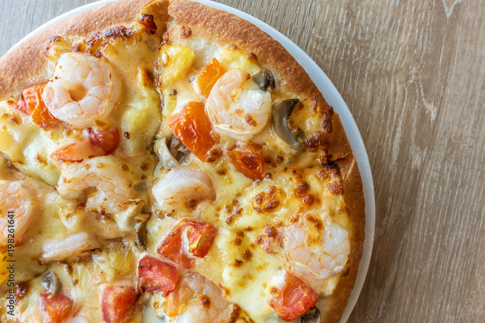 Delicious italian pizza served on wooden table Delicious italian pizza served on wooden table
