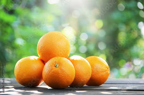 Oranges fruit on wooden table and background.