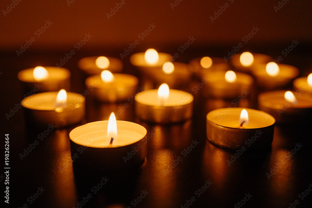 Kemerovo, Russia, fire in the mall, burning candles. Shallow depth of field. Many candles burning at night. Candles background. Many candle flames glowing on dark background. Close-up. Free space. Kemerovo, Russia, fire in the mall, burning candles. Shallow depth of field. Many candles burning at night. Candles background. Many candle flames glowing on dark background. Close-up. Free space.